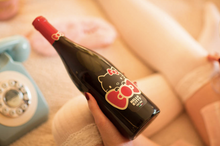 Load the image into the Gallery viewer, Hello Kitty Pinot Noir teddy bear holding a heart with &quot;I love you&quot;
